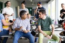 faculty speak at a picnic table