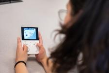 A student plays a video game on a handheld device
