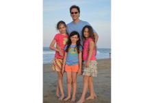 Bill Scherer on the beach with his daughters