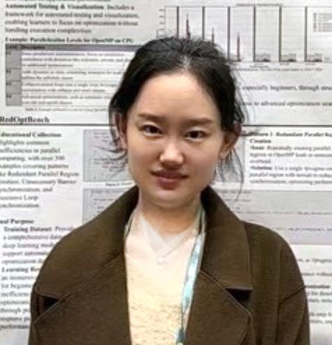 image of woman in brown jacket in front of poster