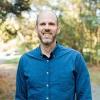 UVA Link Lab Director Jon Goodall is picture in a button down dress shirt outside.