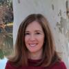 image of Emily smiling standing against tree outside