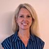 image of woman in blue shirt smiling