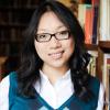 image of woman in blue sweater vest wearing glasses