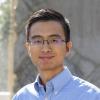image of man wearing glasses with dark hair in blue shirt