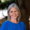 Image of woman in blue shirt smiling outside