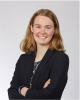 UVA Link Lab Student Committee President, Megan Gunn, is pictured here in an interior headshot, arms folded and smiling in a dark blazer