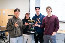 The four members of team No. 7 pose with their trophy, which has four golden ducks up top.