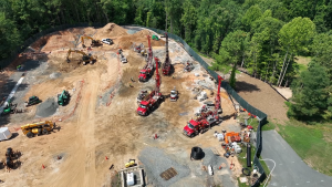 Aerial view of construction site with earth-moving equipment