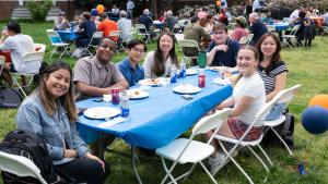 Students pose at a picnic table
