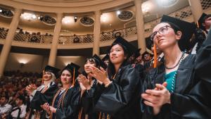 Students clap during the ceremony
