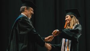 A student receives her diploma