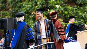 A student shakes the dean's hand