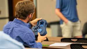 a student examines a prototype