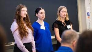 Students listen to questions during their presentation